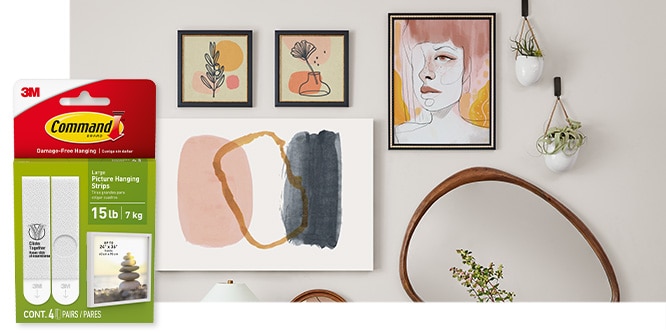 Command™ Large Picture Hanging Strips, behing the product in package, a gallery wall with modern art and mirrors on a wall.
