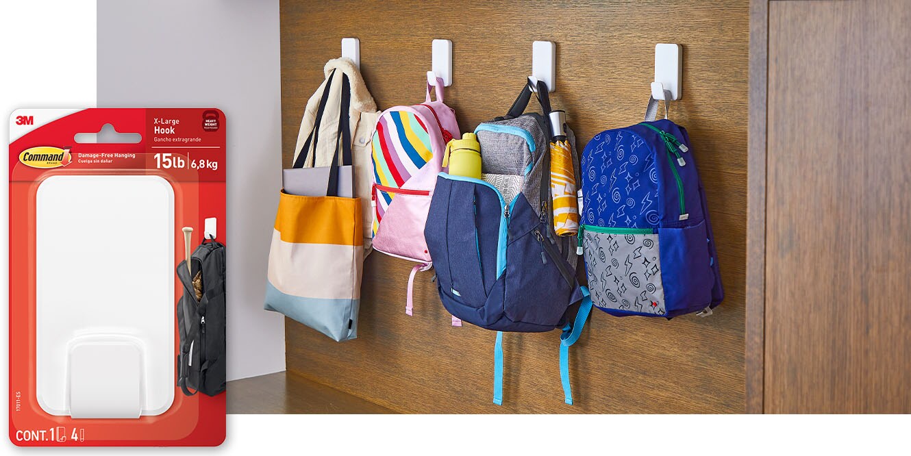 Command™ 15lb X-Large Hooks holding backpacks.
