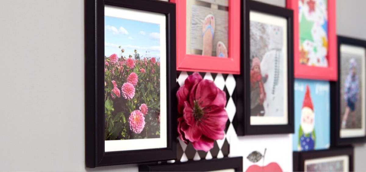 Framed photographs and artwork hung using Command™ Brand products.
