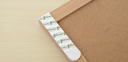 Use Command™ Picture Hanging Strips to attach 2 bulletin boards to the wall.
