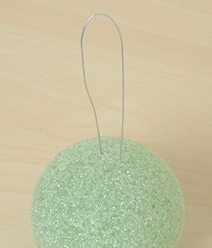 Bend wire in half and insert both ends into the ball and push through until they come out  at the bottom
