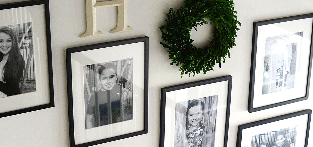 Staircase collage of individually framed family members in black and white offset diagonally.