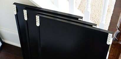 Three black framed picture frames with Command™ Picture Hanging Strips applied waiting to be hung.

