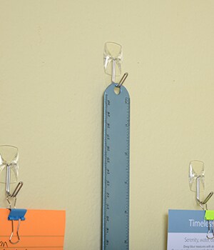 Place Command™ Utensil Hooks on wall to hang supplies on.
