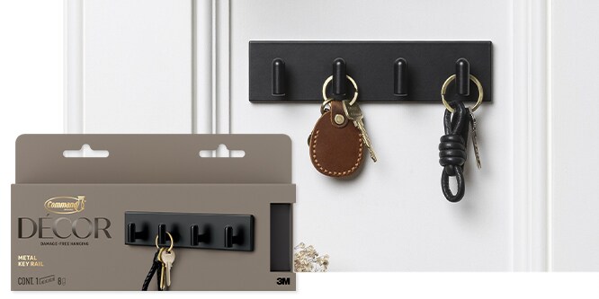 Command™ Metal Key Rail in amtte black holding two sets of keys on a white wall.
