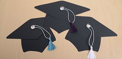 3 assembled hats complete with tassels.
