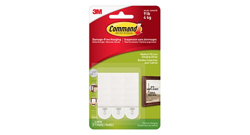 Three Command™ Picture Hanging Strips in their packaging.
