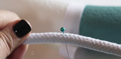 Fold the circle in half to find the half way mark and mark it by inserting a straight pin
