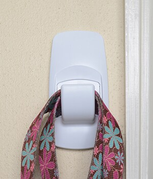 Mount CommandTM Jumbo Hook and Designer Medium Hooks and use them to hold the leash and throwing ring or other toy
