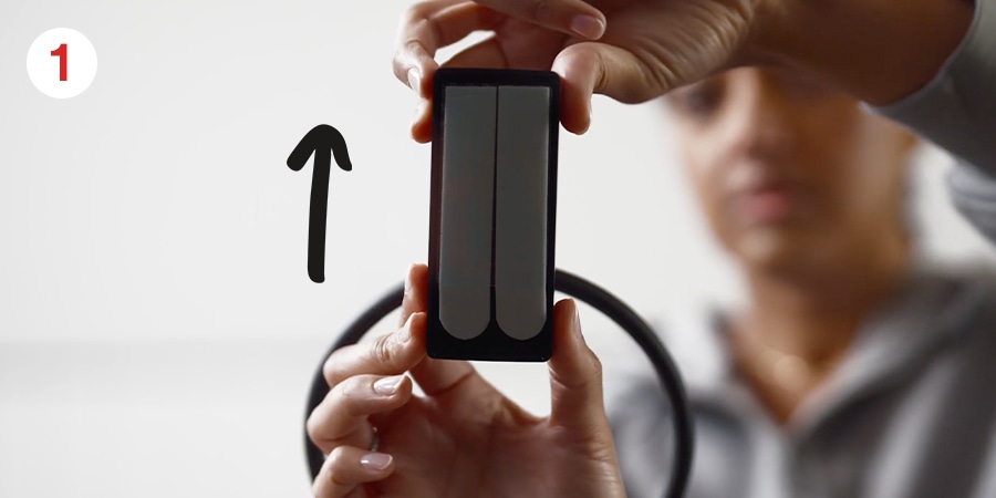 Hands and an arrow show to slide the hook up and off.