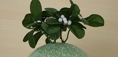 Insert the mistletoe picks all over the foam ball, close together, to completely cover the ball
