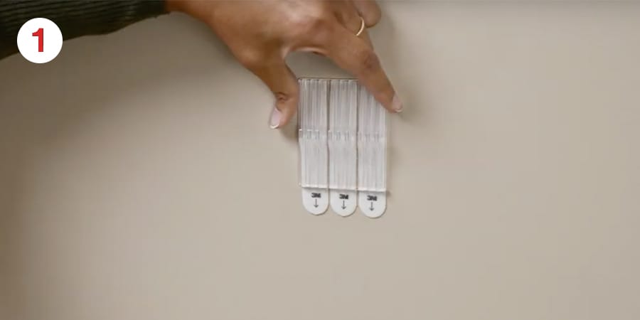 Hands hold the back plate in place.