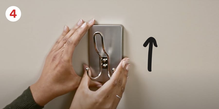 Step 4 - Remove remaining liners. Press frame firmly to wall.