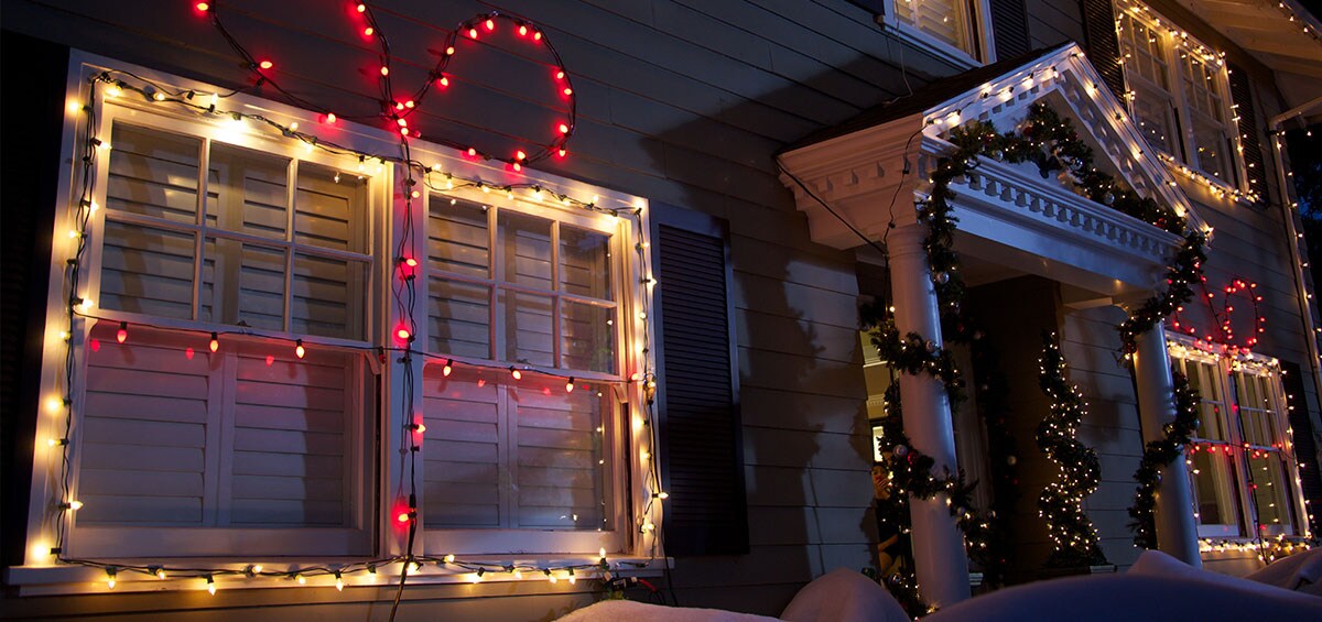 Front of a house exterior decorated for Christmas with lights strung using Command™ light clips.