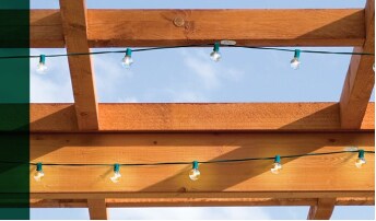 Pergola strung with a string of lights using Command™ Outdoor Light Clips.
