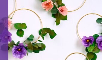 Artificial flowers wrapped around hoops and hung on a wall using Command™ Adjustable Hooks and Clips.
