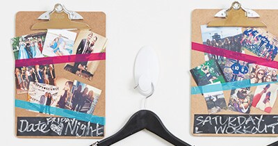 Hook and hanger mounted between two clipboards.
