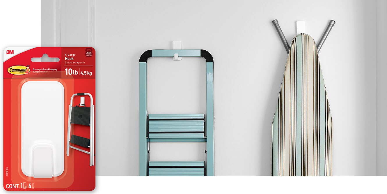 Command™ 10lb X-Large Hook holding a step ladder and an ironing board.
