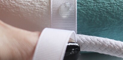 Add a little more hot glue to the front side of the rope to keep the ribbon tight and secure
