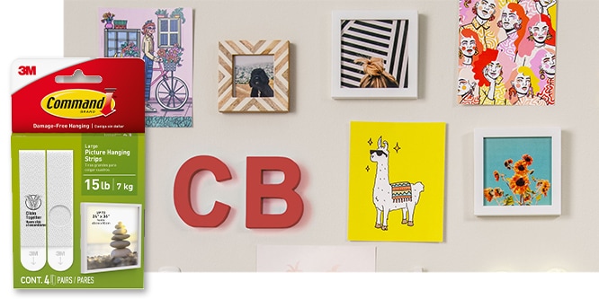 Command™ Large Picture Hanging Strips, behind the product in package, strips are used to hold various images and frames on a gallery wall
