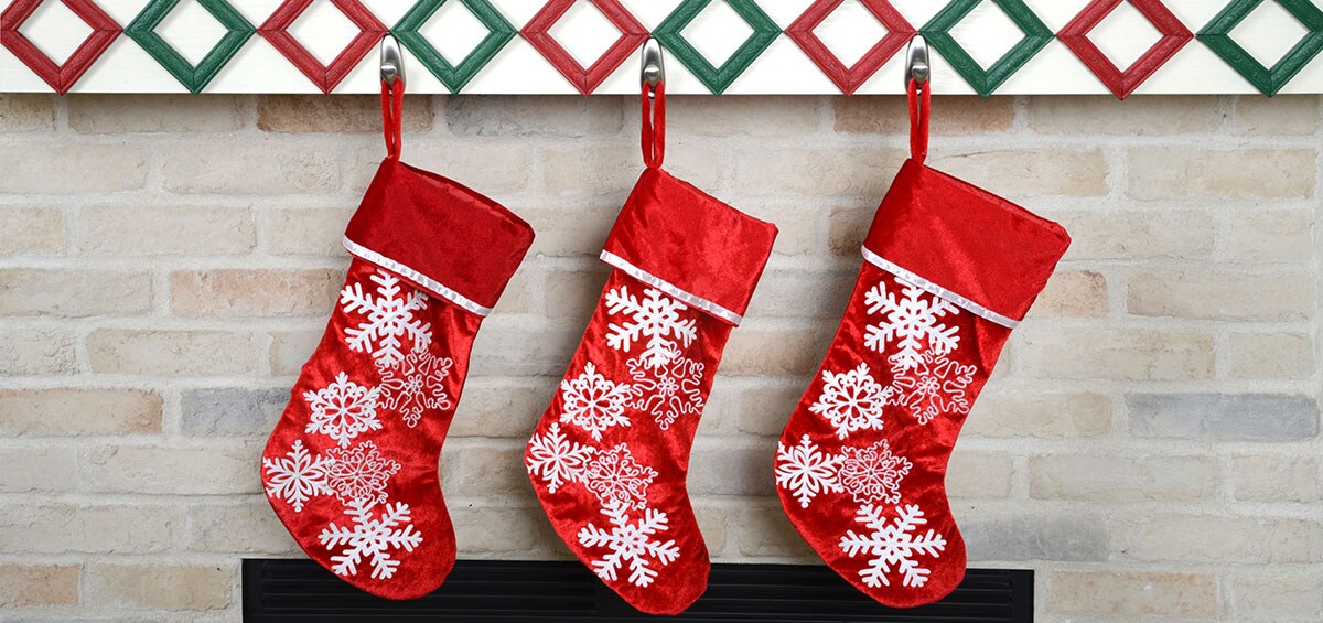 Trois bas de Noël rouges accrochés à l’aide de Crochets métalliques Command(MC).