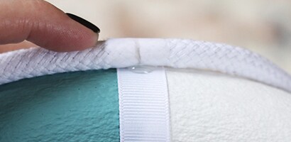 Use a hot glue gun to secure the rope in place on the ribbons
