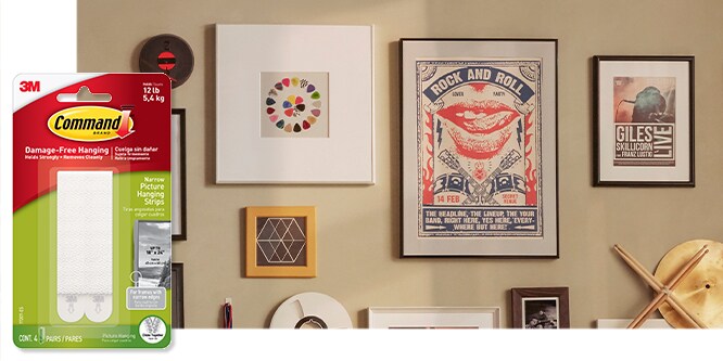 Command™ Narrow Picture Hanging Strips, behind the product in package, a gallery wall with modern art and mirrors on a wall. 
