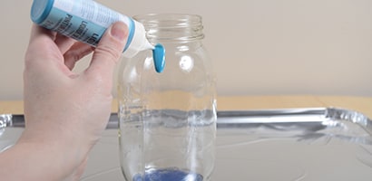 Paint the outside of the jars by letting the paint slowly run down the jars, making sure to cover the glass fully
