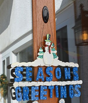 Season's Greetings sign hung on outside of door
