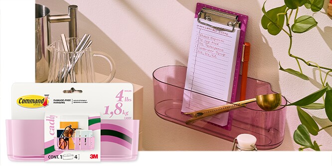 Command™ Caddy holding a clipboard and measuring spoon. Packaging shown on the left.
