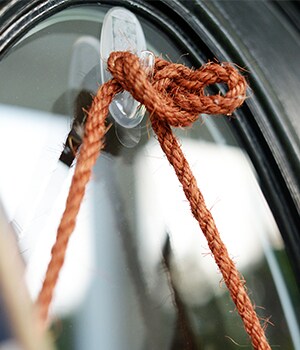 After waiting one hour, hang the basket from the rope on the hook.
