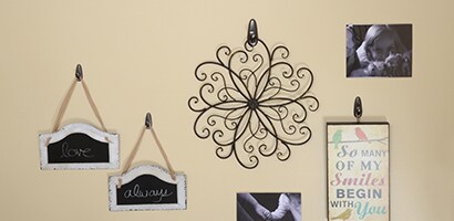Decide where the lowest item will be on the wall and start placing things on the wall from the bottom up
